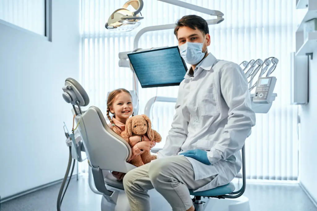 A dentist smiles with a new patient thanks to SEO for pediatric dentists. 