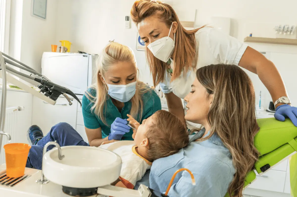 After SEO for pediatric dentists, a dentist helps a new patient. 