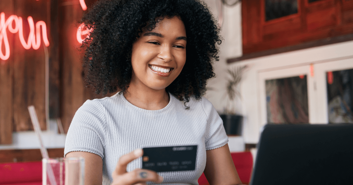 Smiling lady happily paying the dentist she found searching for "dentist near me".