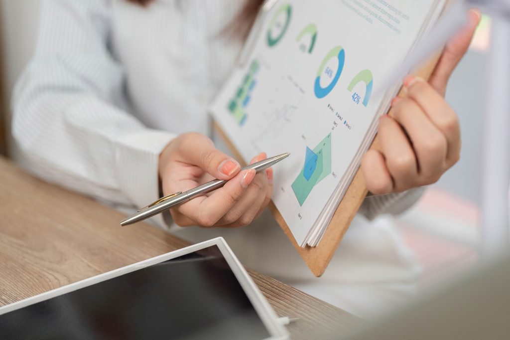 A dental practice owner reviewing a marketing report, with the few numbers that matter highlighted and vanity metrics set aside, illustrating a simple 15-minute monthly review